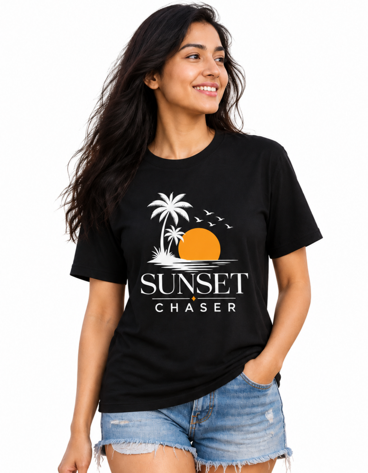 A woman modeling a black graphic t-shirt with a white palm tree, orange sun, and 'SUNSET CHASER' text, paired with denim shorts against a plain white background.