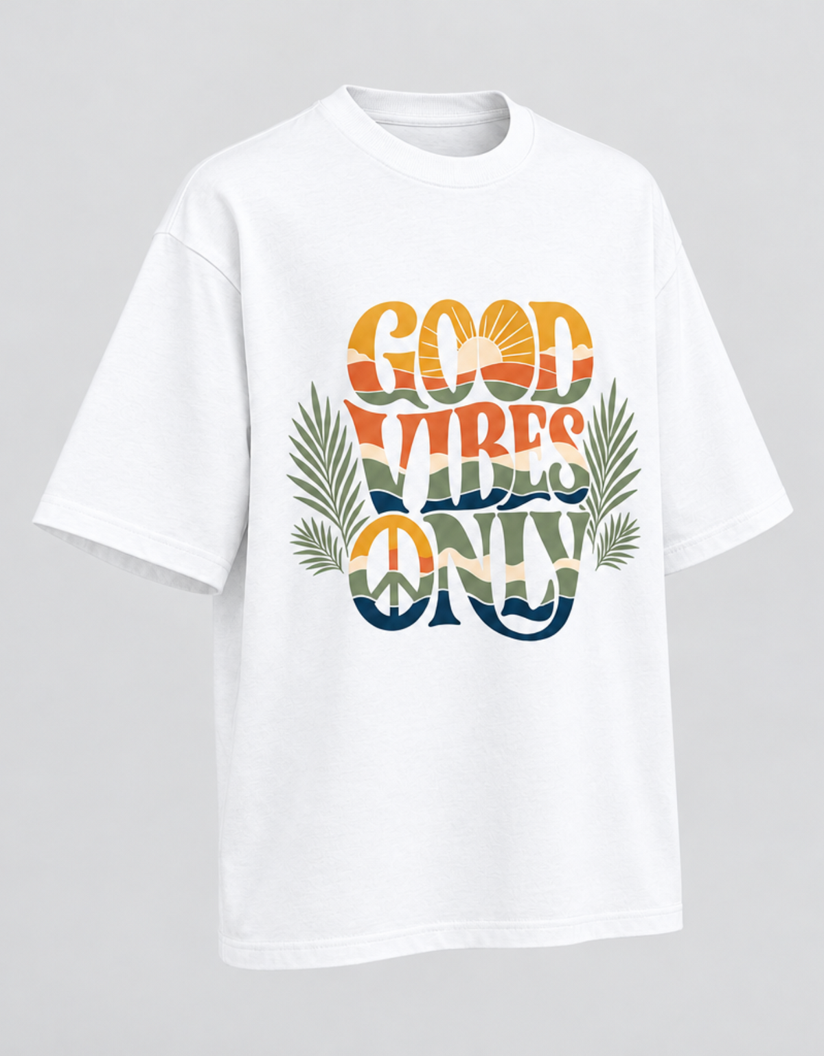 A white short-sleeve t-shirt with a colorful retro graphic reading 'GOOD VIBES ONLY' in layered orange, yellow, green, and blue tones, accented with palm leaves and a peace sign, shown on a light gray background.