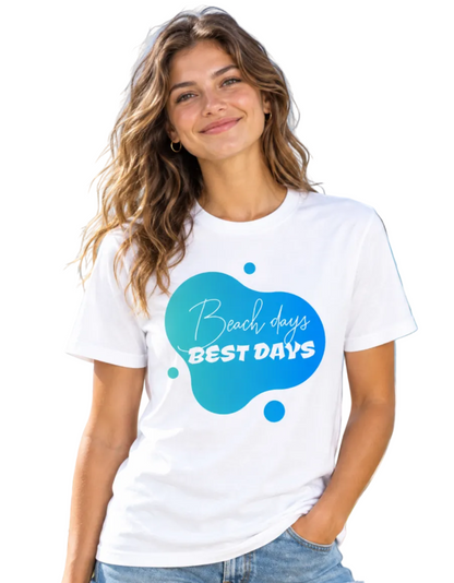 A woman wearing a white short-sleeve t-shirt with a blue and teal graphic on the front that reads 'Beach days BEST DAYS'.