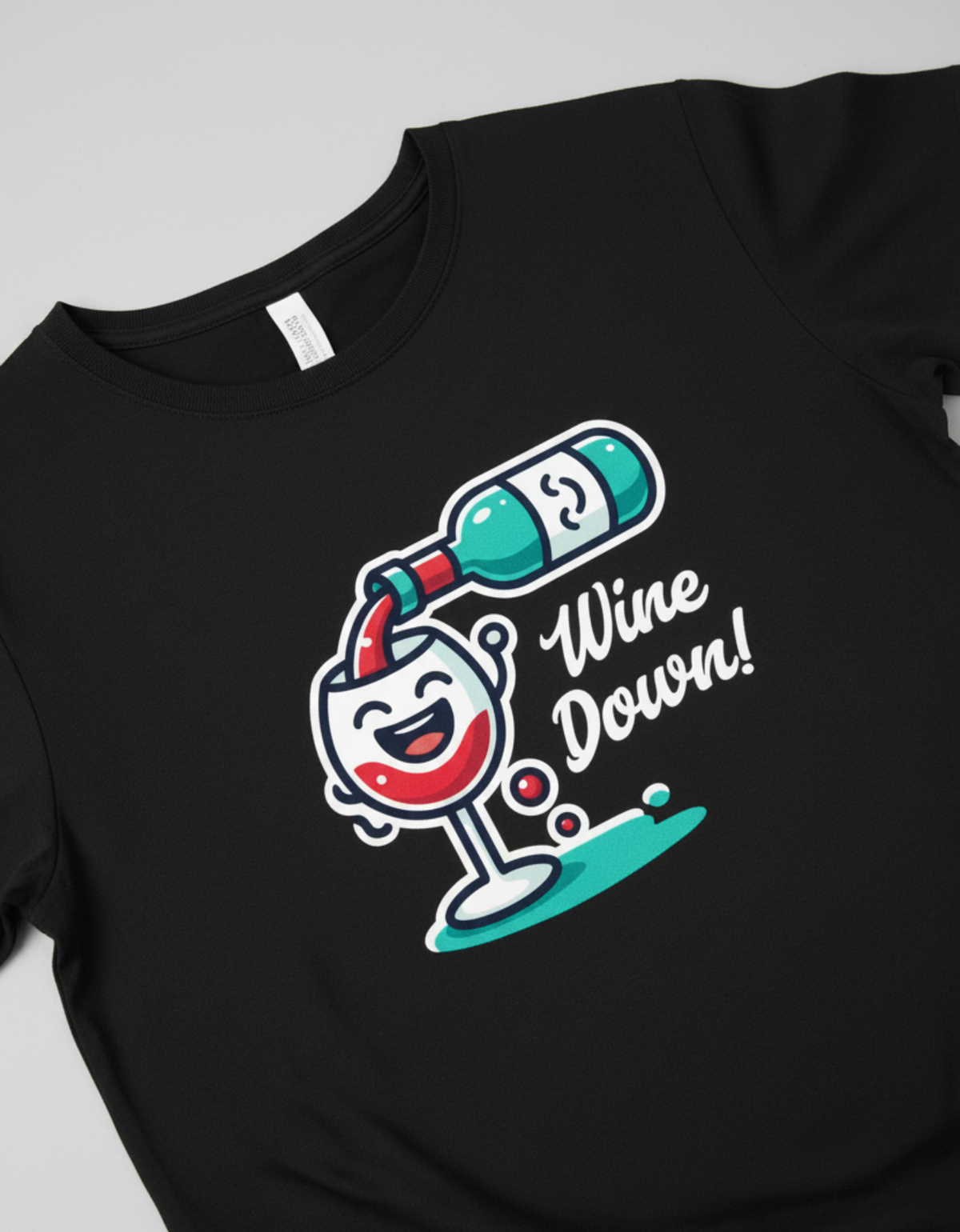 Close-up of the Wine Down graphic featuring a laughing kawaii wine glass and teal bottle printed on a premium black cotton shirt.