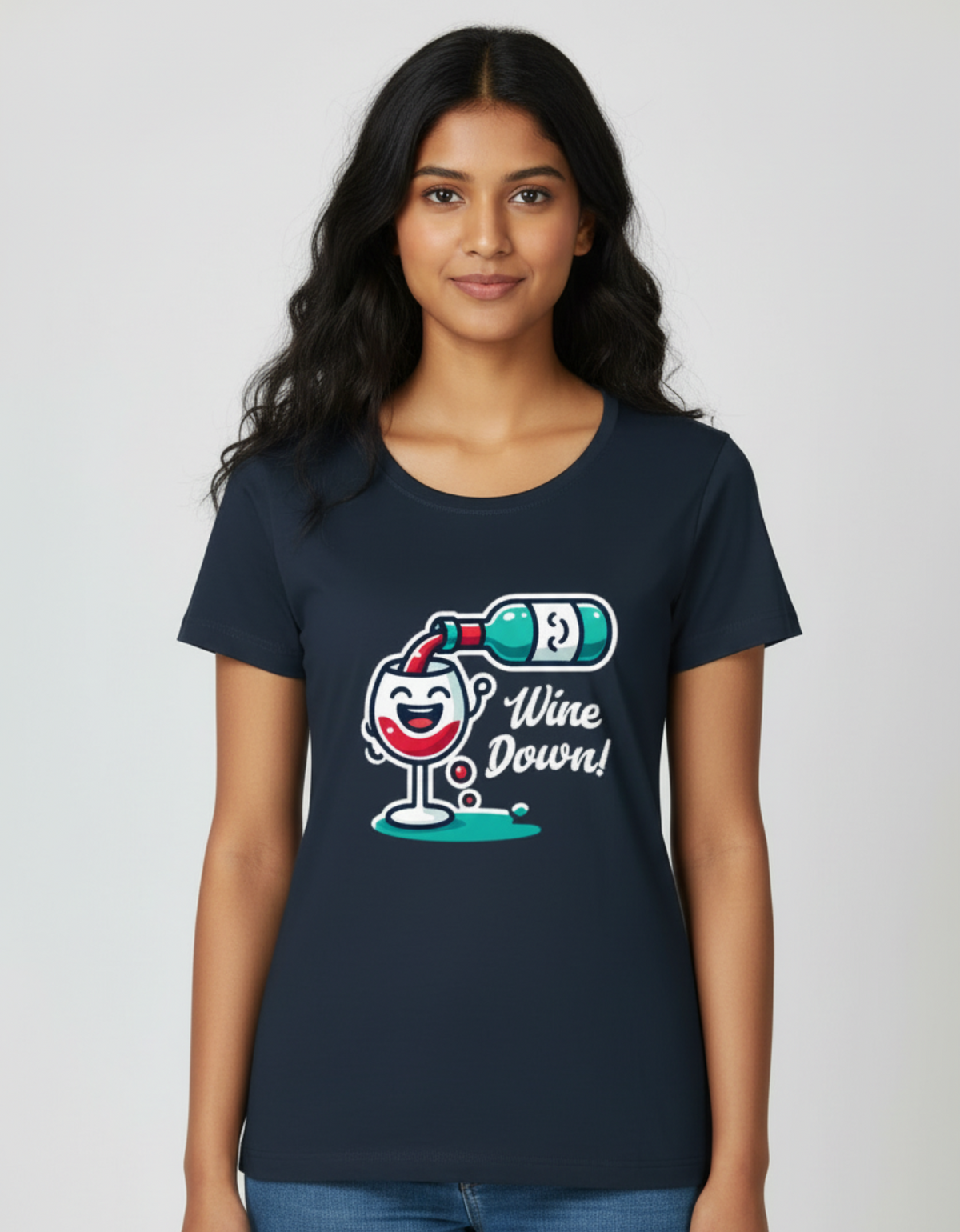 A woman wearing the navy blue Wine Down graphic tee holding a glass of wine on a couch, illustrating a soft bio-washed cotton t-shirt for weekend lounging.