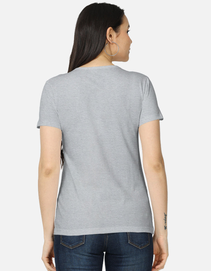 Backside view of the women's crew neck t-shirt. Model wearing a grey 100% super-combed cotton t-shirt with a retro 70s golden hour sunset graphic print by Trendmelo.