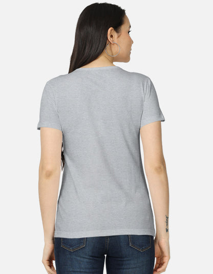 Backside view of the women's crew neck t-shirt. Model wearing a grey 100% super-combed cotton t-shirt with a retro 70s golden hour sunset graphic print by Trendmelo.