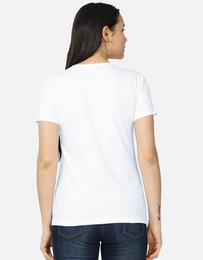 Backside view of the women's crew neck t-shirt. Model wearing a white 100% super-combed cotton t-shirt with a retro 70s golden hour sunset graphic print by Trendmelo.